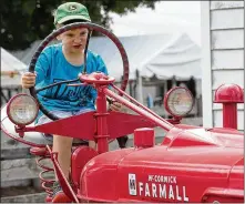  ?? BILL LACKEY/STAFF ?? Ethan Napier, 4, pretends to drive a tractor at the Champaign County Fair.