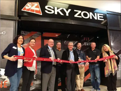  ?? GLENN GRIFFITH -MEDIANEWS GROUP ?? Sky Zone Trampoline Center in Clifton Park Center is a place where one can literally have fun bouncing off the walls. Officials with the Chamber of Southern Saratoga County and local elected representa­tives joined owner Rusty Saunders for the opening. Saunders is second from the right, with scissors, in the photo.