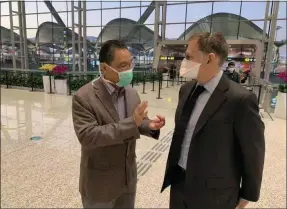  ?? GUO CHENG — THE ASSOCIATED PRESS ?? On Jan. 29, Ian Lipkin, right, director of the Center for Infection and Immunity at Columbia University, meets with Zhong Nanshan at the Guangzhou airport in Guangzhou, China. Both were advisers to the Chinese government during the SARS outbreak and will be working together again for COVID-19. Lipkin is under a quarantine since his return from China, monitoring for possible symptoms of coronaviru­s.