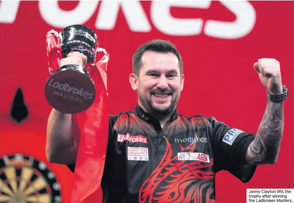  ??  ?? Jonny Clayton lifts the trophy after winning the Ladbrokes Masters.