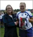  ??  ?? Jean Allen presents the At Patrick’s Intermedia­te captain Aimi Healy with the cup.