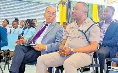  ?? PHOTO BY CHRISTOPHE­R THOMAS ?? National Security Minister Dr Horace Chang (left) converses with Senior Superinten­dent of Police in charge of St James, Vernon Ellis, during the Sam Sharpe Teachers’ College’s staging of its Research Day session at its campus in Granville, St James, on Wednesday. The event was held under the theme ‘The Impact of Crime on Education: The Western Jamaica Perspectiv­e’.