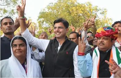  ??  ?? Rajasthan Congress chief Sachin Pilot and Congress candidate Raghu Sharma flash victory sign after the latter’s victory in Ajmer Lok Sabha bypoll in February.