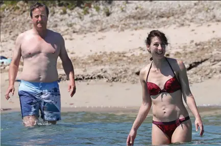  ??  ?? Welcome escape: David Cameron goes swimming in Corsica with wife Samantha following his resignatio­n