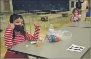  ?? COURTESY OF NORTH PENN SCHOOL DISTRICT ?? Gwyn Nor Elementary students, wearing masks and staying safely distanced, give thumbs-up while having lunch during their first day of in-person instructio­n Monday.