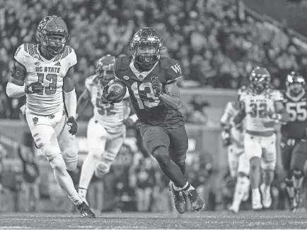  ?? WILLIAM HOWARD/USA TODAY SPORTS ?? Wake Forest wide receiver Ke'shawn Williams runs after a catch against North Carolina State linebacker Tyler Baker-williams, left, on Saturday in Winston-salem, N.C.