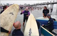  ?? AP FILE PHOTO BY RICHARD VOGEL ?? In this 2010 photo, Rev. Christian Mondor, offers a prayer to surfers during the Blessing of the Waves ceremony at the pier in Huntington Beach.