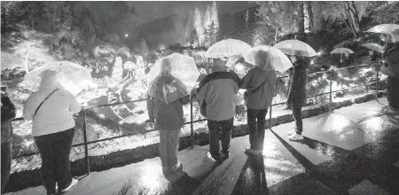  ??  ?? Compliment­ary umbrellas came in handy in the rain at the start of the light-up event.