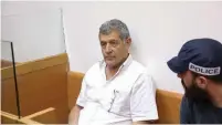  ??  ?? MIKI GANOR, arrested in the submarine probe, is brought for a hearing at the Magistrate’s Court in Rishon Lezion last week.