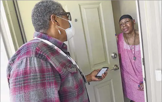  ?? Photos by Lori Van Buren / Times Union ?? Cessie Alfonso, a census outreach worker with Capital District Latinos, stops by the home of Albany resident Essie Goodlett last week to ask if she has completed her census form.