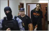  ?? EVGENIA NOVOZHENIN­A — POOL PHOTO VIA AP ?? American basketball star Brittney Griner, right, is escorted Wednesday to a courtroom in Khimki, Russia.