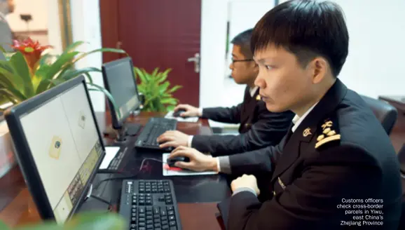  ??  ?? Customs officers check cross-border parcels in Yiwu, east China’s Zhejiang Province