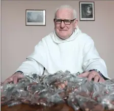  ??  ?? Fr Jim Donleavy of the Dominican community with some of the ‘Pennies from Heaven’ collection that provided vital roof repairs in 2017