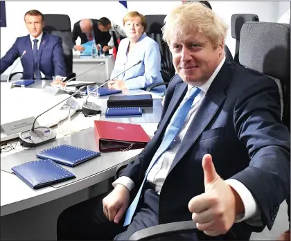  ??  ?? Positive... Mr Johnson gives a thumbs up to the press on the final day of the G7 summit in France yesterday