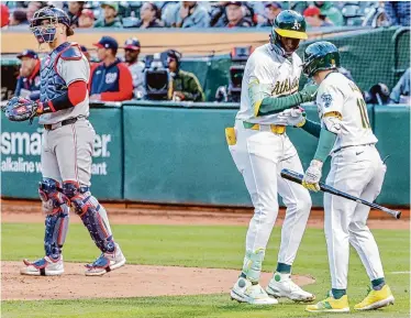  ?? Santiago Mejia/The Chronicle ?? Oakland's Lawrence Butler celebrates with teammate Nick Allen, right, after hitting a solo home run in the third inning of Friday night's game against the Nationals at the Coliseum.