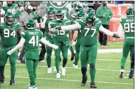  ?? Bill Kostroun / Associated Press ?? Jets offensive tackle Mekhi Becton (77) celebrates after the Jets stopped the Browns on a fourth-down play in Sunday’s game.