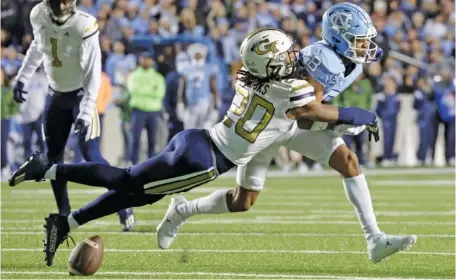  ?? AP PHOTO/CHRIS SEWARD ?? Georgia Tech defensive back LaMiles Brooks breaks up a pass intended for North Carolina wide receiver Kobe Paysour during Saturday’s game in Chapel Hill, N.C.. The Yellow Jackets upset No. 13 North Carolina 21-17.