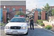  ?? [AP FILE PHOTO] ?? A police officer stands by a locked gate Sept. 17, 2013, at the Washington Navy Yard in Washington. The Defense Department is poised to take over background investigat­ions for the federal government. The change aims to fix a system whose weaknesses...