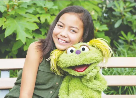  ?? FLYNN LARSEN/SESAME WORKSHOP ?? Salia Woodbury, 10, whose parents are in recovery, bonds with Karli, the Sesame Street muppet whose “mother” is also recovering from a substance-abuse disorder. Both are sharing their stories in the hopes of helping other kids facing the same issues.
