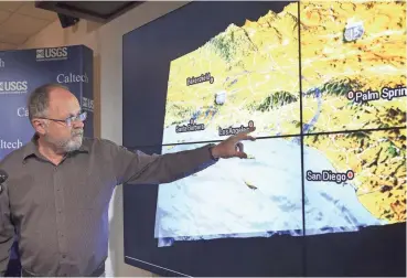  ?? NICK UT/AP ?? Egill Hauksson, a Caltech seismologi­st, looks at earthquake data in 2014.