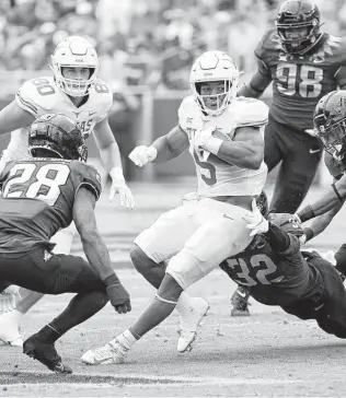  ?? Ron Jenkins / Associated Press ?? UT running back Bijan Robinson leads the nation in yards from scrimmage (819) and is second in rushing yards (652). Against TCU on Oct. 2, he rushed 35 times for 216 yards and scored twice.