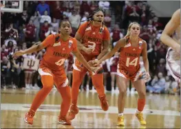  ?? DARRON CUMMINGS – THE ASSOCIATED PRESS ?? Miami's Destiny Harden, center, is joined by teammates Jasmyne Roberts, left, and Haley Cavinder after hitting a key shot late in Monday night's upset victory over Indiana.