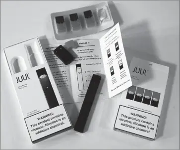  ?? Eva Hambach AFP/Getty Images ?? THE JUUL, a vaporizer with a cigarette pack’s worth of nicotine and f lavors such as cucumber, has sparked concerns about health and its appeal to youths. The company says its mission is to help adults quit smoking.