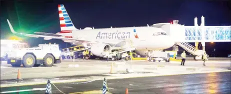  ??  ?? American Airlines on Thursday night at the boarding bridge at the CJIA. (DPI photo)