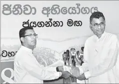  ??  ?? JHU National Organiser Nishantha Warnasingh­e hands over a copy of the 18-fold programme compiled by him to Minister Patali Champika Ranawaka. Pic by Waruna Wanniarach­chi