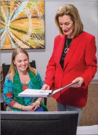  ?? WILLIAM HARVEY/THREE RIVERS EDITION ?? Sandra Massey, right, chancellor at Arkansas State University-Newport, discusses a report with Kristen Smith, assistant to the chancellor. Massey has been chancellor at the university since 2013 and was the first female named chancellor of an...