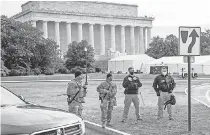  ?? BRIAN MUNOZ/ USA TODAY ?? Federal agents and members of the Florida National Guard watch over the Lincoln Memorial on Sunday in Washington.