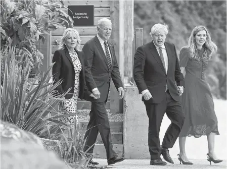  ?? REUTERS ?? Britain’s Prime Minister Boris Johnson, second from right, his wife Carrie Johnson and U.S. President Joe Biden with first lady Jill Biden walk outside Carbis Bay Hotel in Carbis Bay, Cornwall, Britain, on Thursday.