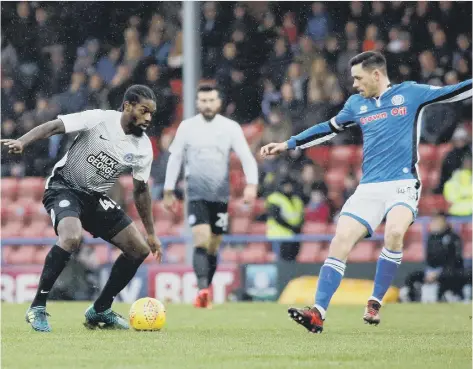  ??  ?? Anthony Grant of Peterborou­gh United takes on Ian Henderson of Rochdale in the League One clash in November. Posh lost 2-0.