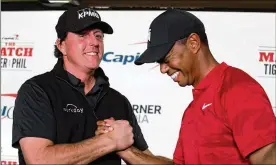  ?? HARRY HOW / GETTY IMAGES ?? PGA Tour stars Phil Mickelson and Tiger Woods used to be bitter rivals, but the relationsh­ip improved in recent years.