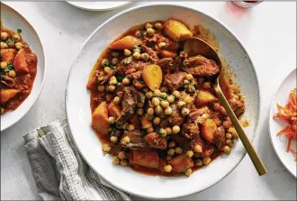  ?? DAVID MALOSH PHOTOS/THE NEW YORK TIMES ?? Lamb shanks with apricots and chickpeas in New York on Oct. 22 Braised shanks, a carrot salad and a molasses ginger cake: This cozy menu from David Tanis, drawing from North Africa, is sure to warm. Food styled by Simon Andrews.