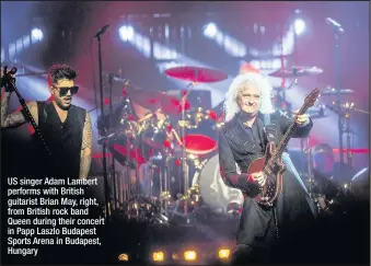  ??  ?? US singer Adam Lambert performs with British guitarist Brian May, right, from British rock band Queen during their concert in Papp Laszlo Budapest Sports Arena in Budapest, Hungary