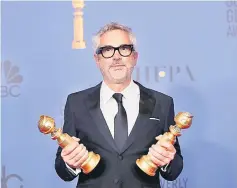  ??  ?? Alfonso Cuaron poses backstage with his Best Director - Motion Picture and Best Motion Picture - Foreign Language for ‘Roma’.