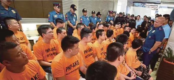  ?? [ FOTO AFP ] ?? Dela Rosa (kanan) bertemu sekumpulan 44 suspek penculik yang ditahan polis Filipina di Manila, semalam.