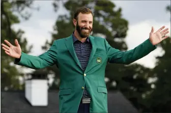  ?? ASSOCIATED PRESS FILE PHOTO ?? Masters golf champion Dustin Johnson shows off his green jacket after his 2020 victory in Augusta, Ga.