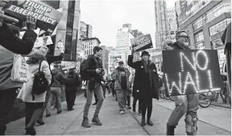  ?? Frank Franklin II / Associated Press ?? Protesters of President Donald Trump’s national emergency declaratio­n gather in New York. The Trump Organizati­on is backing away from hotel deals, citing potential blowback for the president.