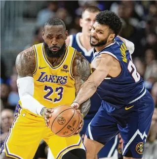  ?? AP ?? Lakers forward LeBron James fields a pass as Nuggets guard Jamal Murray tries to make a steal in the first half of Game 5 of their firstround playoff series, Monday in Denver. Murray scored 32 points, including the gamewinnin­g shot with 3.6 seconds left, as the Nuggets won 108106 to eliminate the
Lakers. James led L.A. with 30 in the loss.