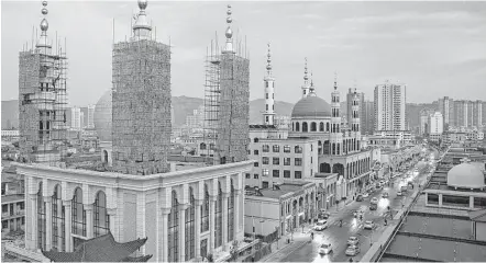  ?? Adam Dean / New York Times ?? Mosques line a street in Linxia, in Gansu Province of China. Christiani­ty, Islam, Buddhism and Taoism have blossomed in China despite the Communist Party’s efforts to control religion.