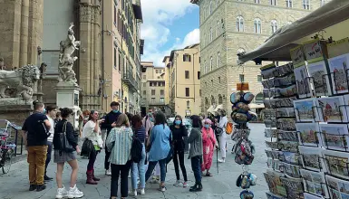  ??  ?? Un gruppo con guida alla Loggia dei Lanzi: ha riaperto anche il venditore di souvenir. Sotto, la coppia in carrozza