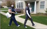  ?? BEN HASTY — MEDIANEWS GROUP ?? Johannie Rodriguez, a licensed practical nurse, and Jennifer Grandstrom, a registered nurse, arrive at Connie Ramsey’s house in Spring Township on Thursday to give her and her daughter, Jodie, doses of the Moderna COVID-19vaccine. Nurses from the Berks Community Health Center partnered with the Berks County Area Agency on Aging to provide in-home vaccinatio­ns for people who are homebound.