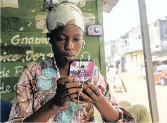  ?? EPA African News Agency (ANA) ?? A WOMAN uses a cellphone in Abidjan, Ivory Coast. Mobile network operators have stiff competitio­n for the millions of African consumers looking to connect, but there is a growing trend among government­s on the continent to shut down internet and broadcasti­ng services to stifle dissent. |