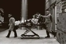  ?? Lisa Krantz / Staff photograph­er ?? Paramedics transfer a patient with COVID-19 from a San Antonio hospital to home hospice care in July. Essential workers should not have to wait to receive benefits “until we are disabled or dead.”