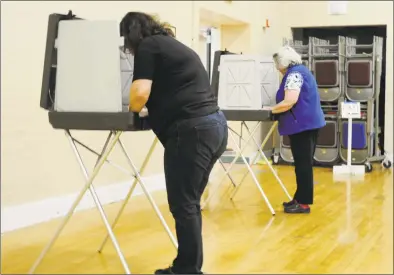  ?? Julia Perkins / Hearst Connecticu­t Media ?? Angela Gabordi, left, and Eleanor Gabordi vote on the $31.6 million Bethel town budget at the Clifford J. Hurgin Municipal Center on Tuesday. Bethel voters approved the second attempt to pass the budget.