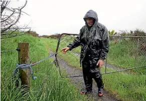  ??  ?? Dairy farmer Iain MacGregor says the people who dumped trash could have caused an accident had stock wandered out of the open gate and on to the road. ROBYN EDIE/STUFF