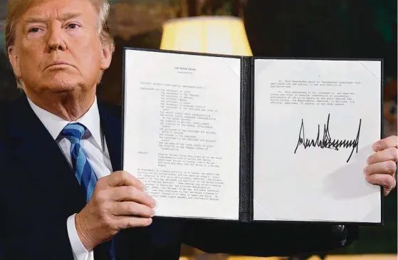  ?? Picture: AFP ?? US President Donald Trump signs a document reinstatin­g sanctions against Iran and (below) Iranian President Hassan Rouhani.