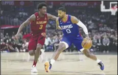  ?? Associated Press ?? Los Angeles Clippers guard Paul George (13) controls the ball against Cleveland Cavaliers guard Caris LeVert (3) during the first half on Monday in Los Angeles. The Clippers won 119-117.